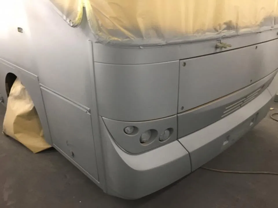 Coach in grey primer part way through a respray at OH Works in Fairford