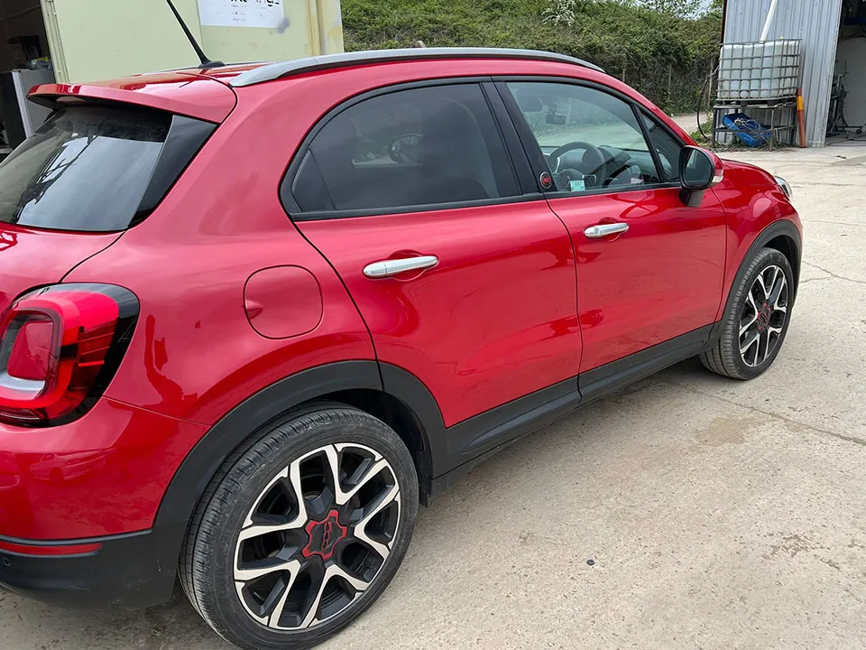 Red Fiat 500X door crease repaired and resprayed at OH Works in Fairford