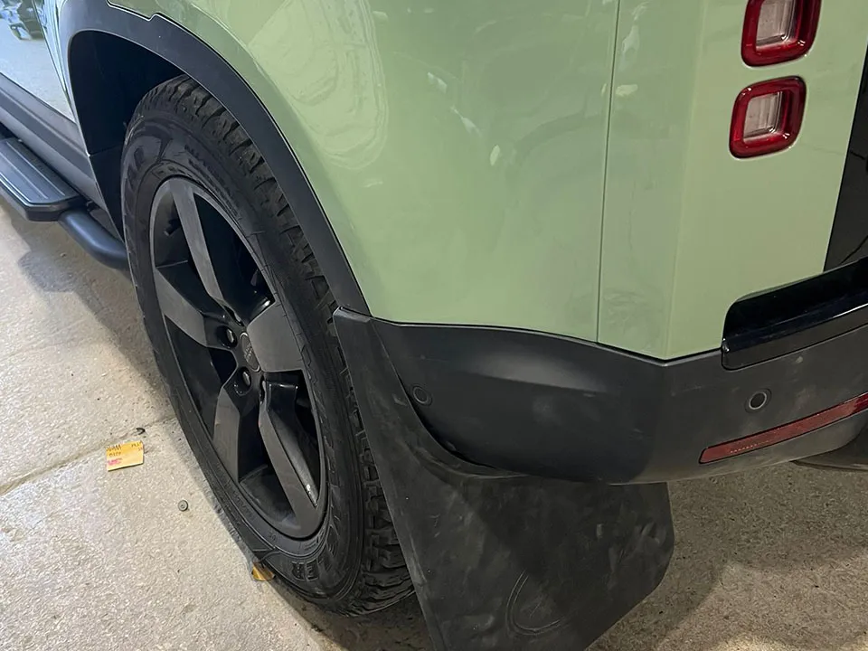 Green Land Rover Defender rear quarter repaired and refinished at OH Works in Fairford