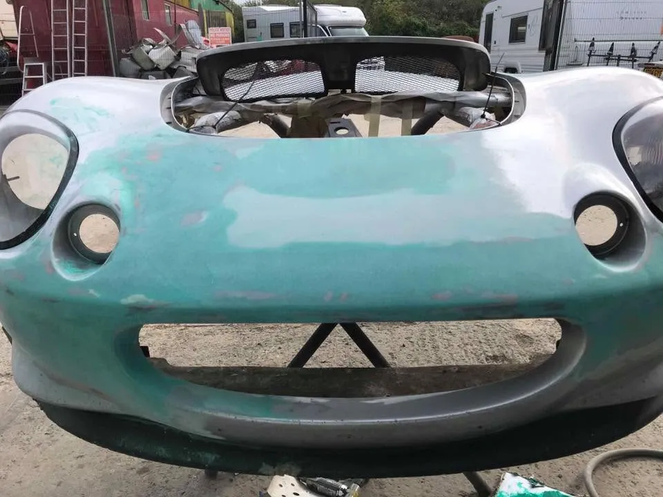 Lotus Elise in primer during restoration at OH Works in Fairford