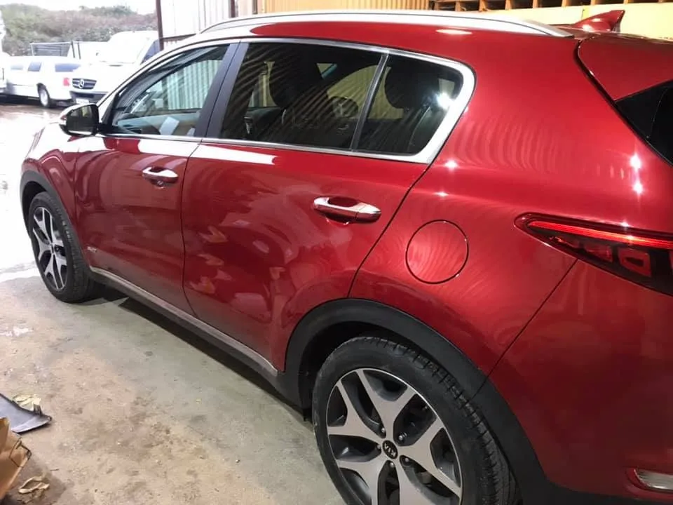 Red Kia Sportage rear quarter resprayed and finished at OH Works in Fairford