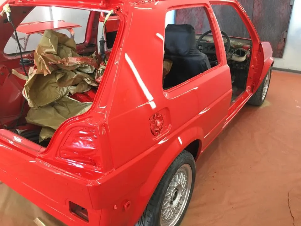 Red VW Golf rear quarter resprayed during restoration at OH Works in Fairford